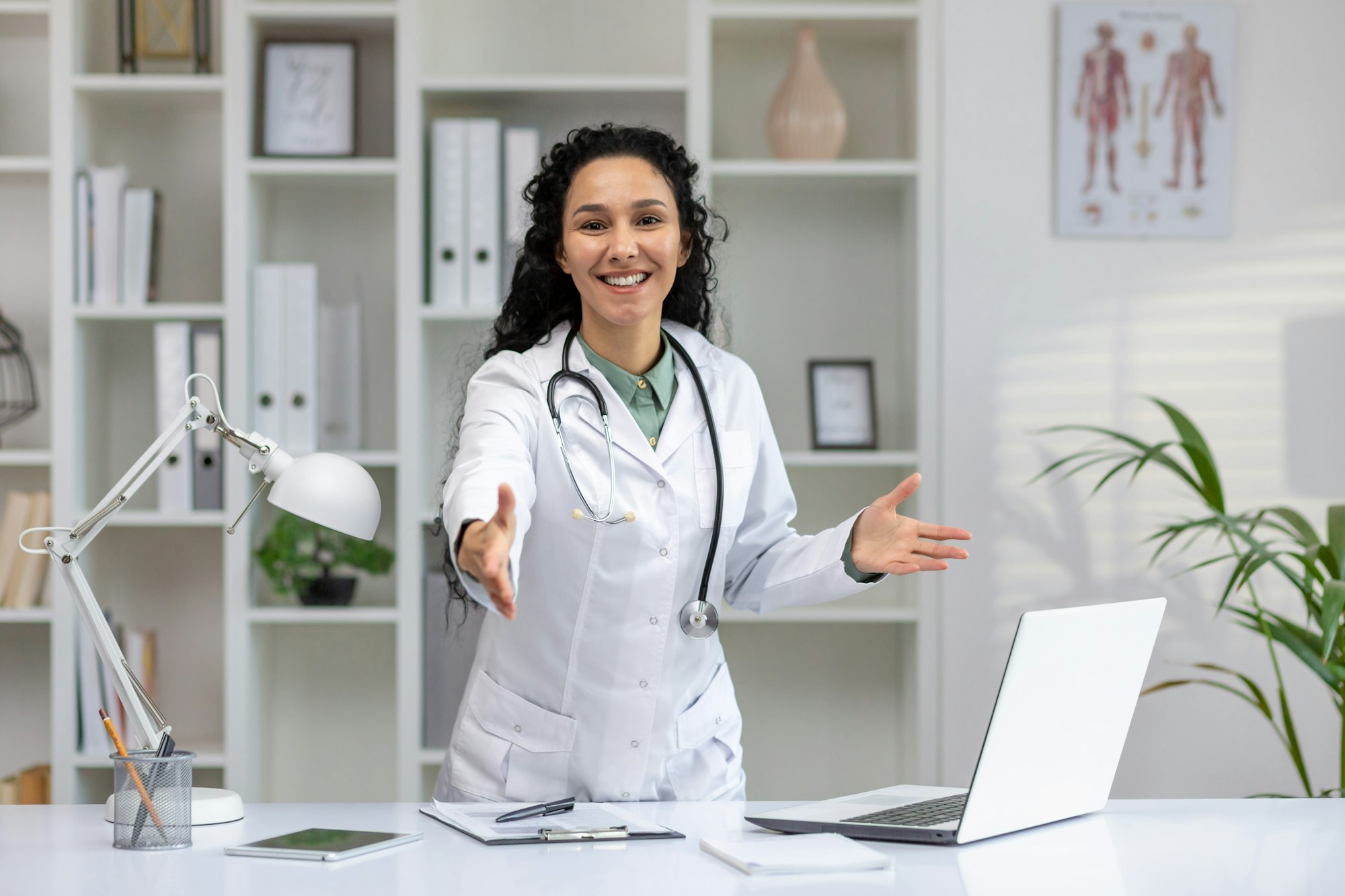 Hispanic female doctor in a welcoming pose at clinic